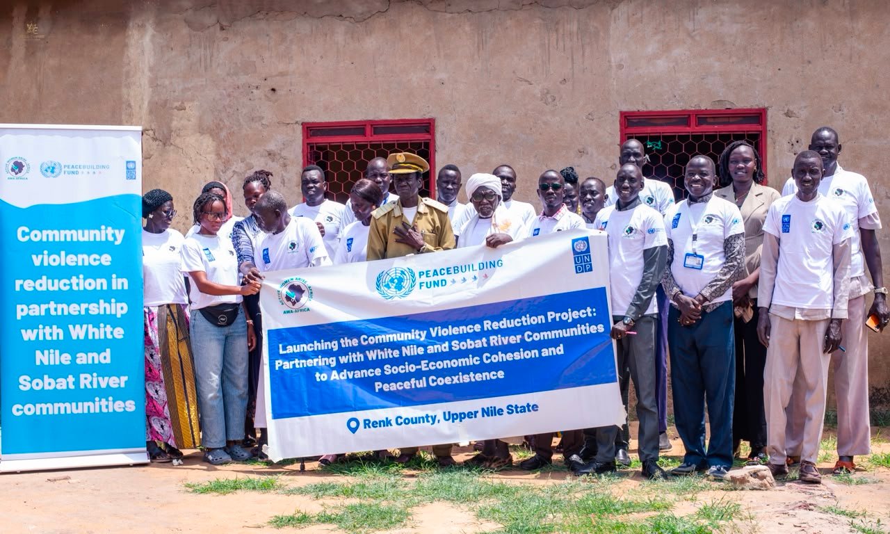 Participants and AWA-AFRICA staff with the project banner at the launch in Renk County
