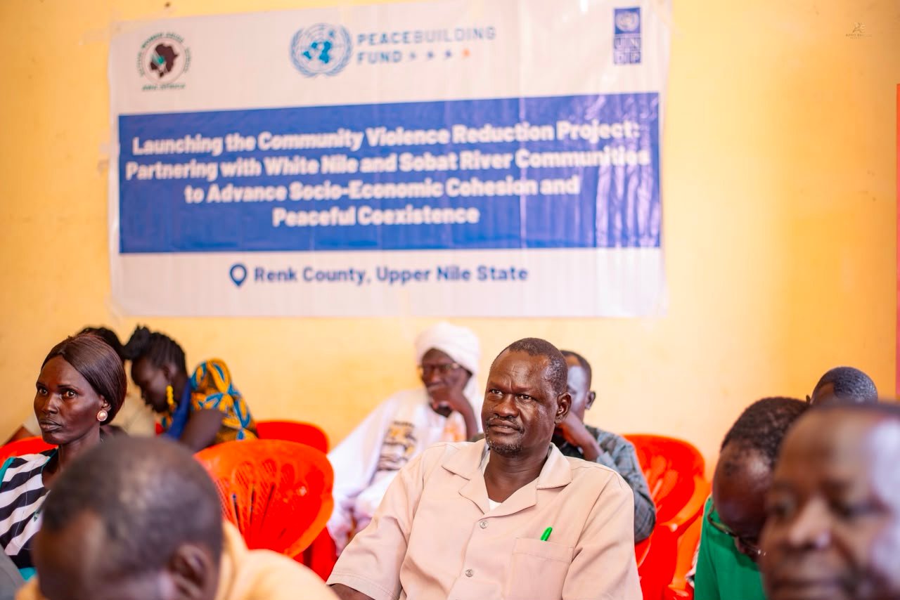 Participants seated at an AWA-AFRICA workshop beside the project banner